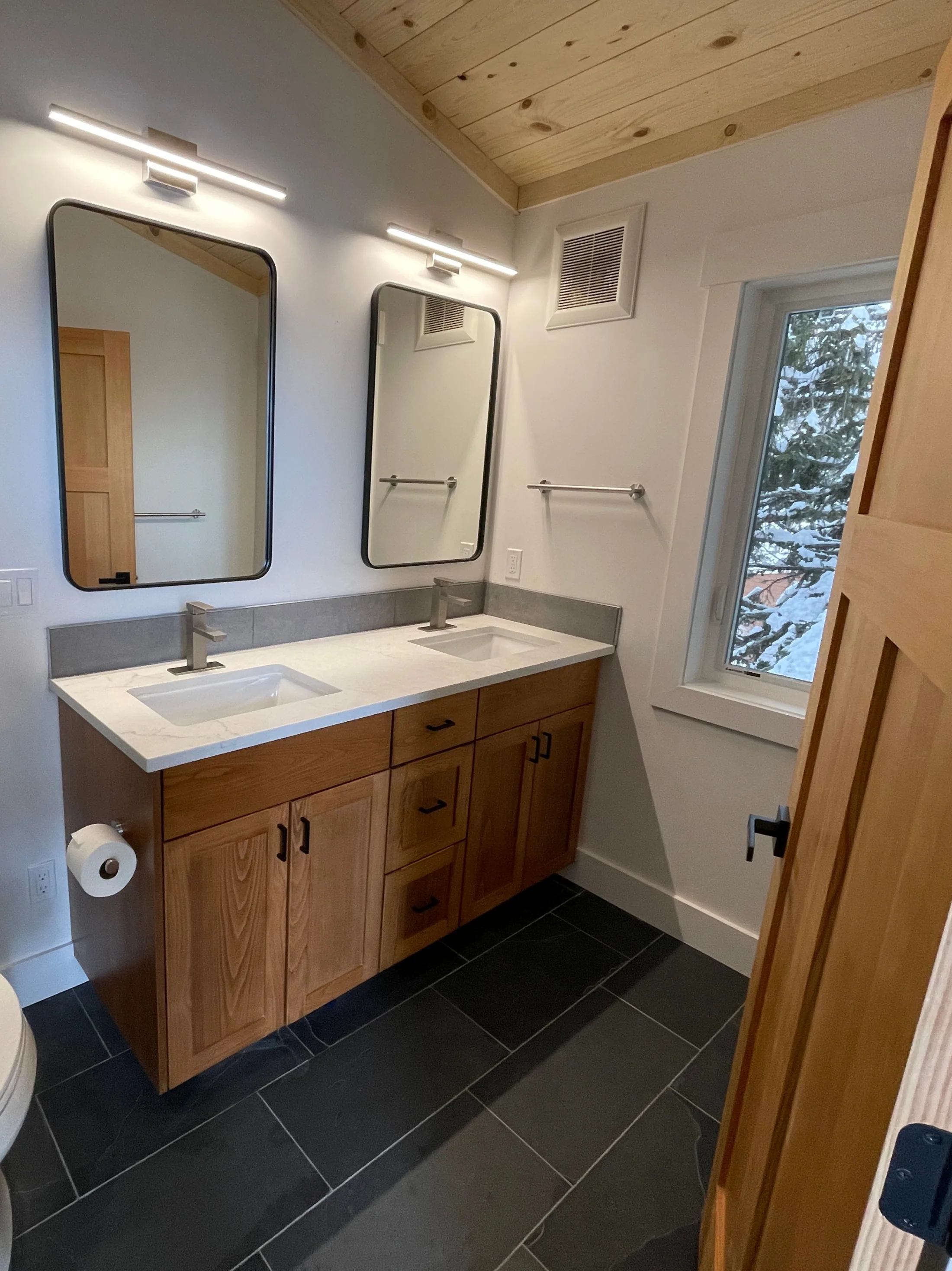 Natural wood double bathroom vanity with integrated cabinetry and open shelving